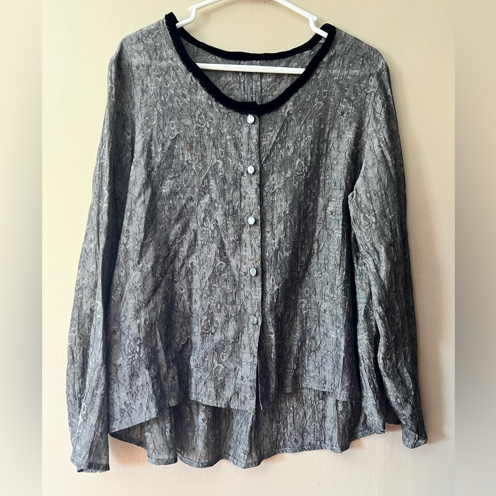 Grey semi sheer textured button up blouse with long sleeves and high low style.